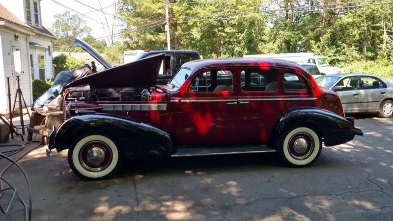 Vintage sedan restoration with hood up